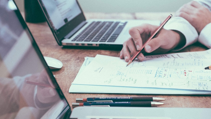 Person reviewing documents at a desk