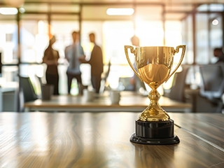 trophy on desk with people planning in background