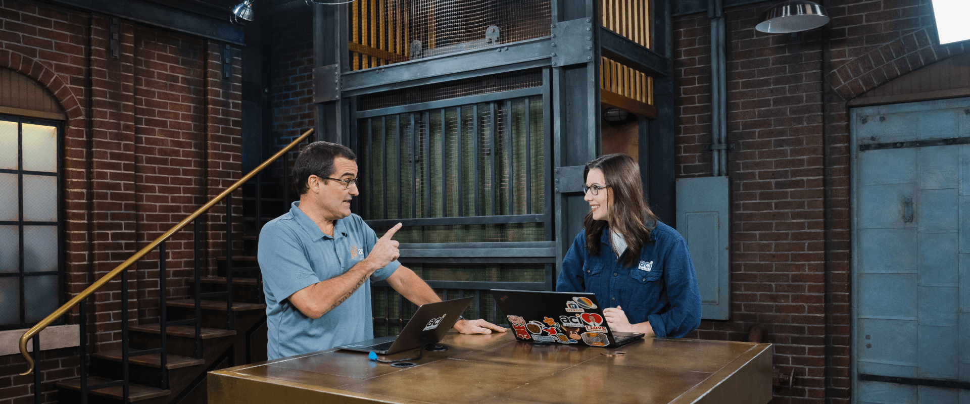 two people with laptops discussing something